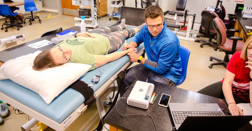 Ian Greenlund uses applanation tonometry to take a resting blood pressure measurement.