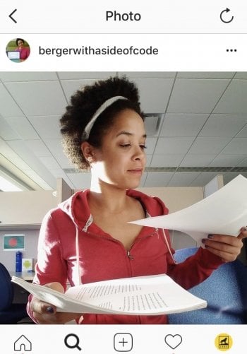 young woman holding academic papers in her hands in a room