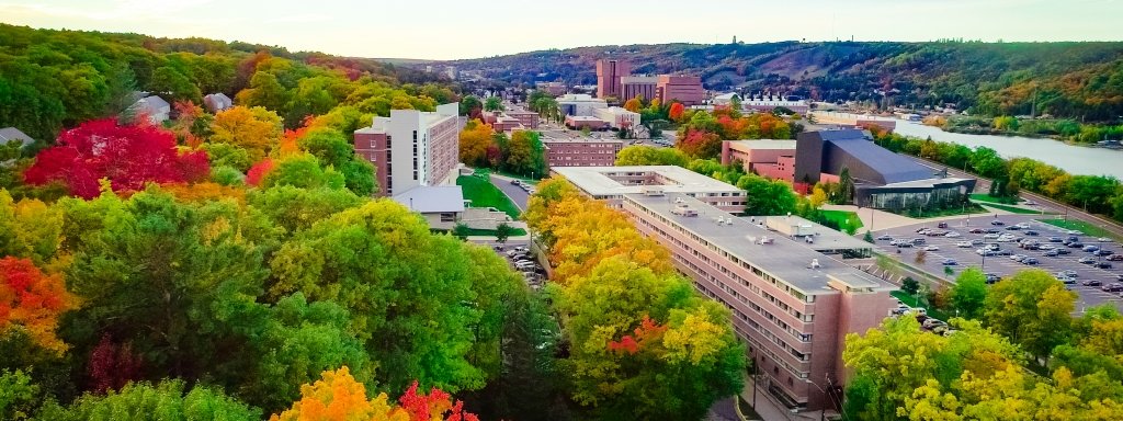 Drone view of the Michigan Technological University Campus on the Houghton, Michigan waterfront with fall colors, buildings and the Portage Lake Lift Bridge in the background.,   