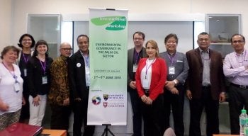 A group of researchers standing with the conference banner.