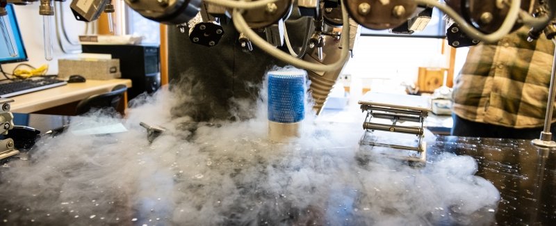 Liquid nitrogen vapor erupts from a container beneath a vacuum line in the Carbon, Water and Soils Lab.