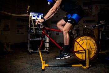 man on a stationary bike with a respirator mask and tubes