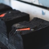 black molds with bright orange molten metal in the center