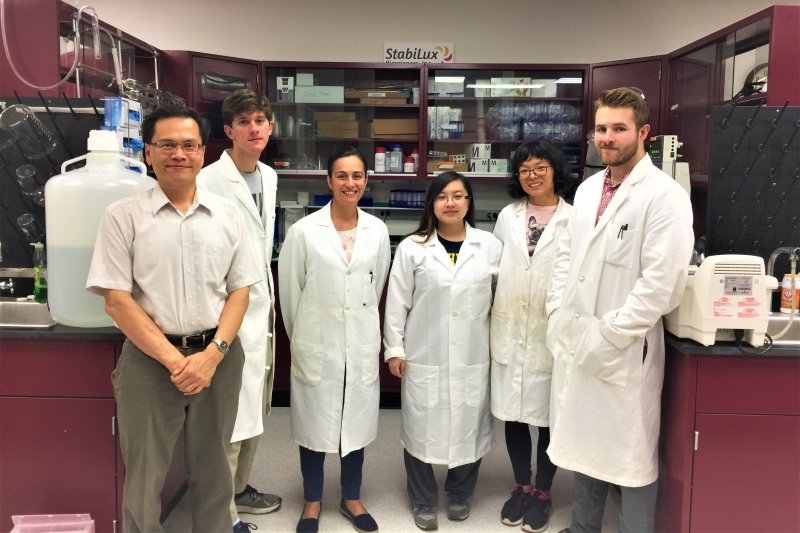 group of people standing in lab coats