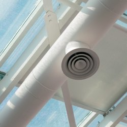 air flltration ducts in a white ceiling with blue sky outside