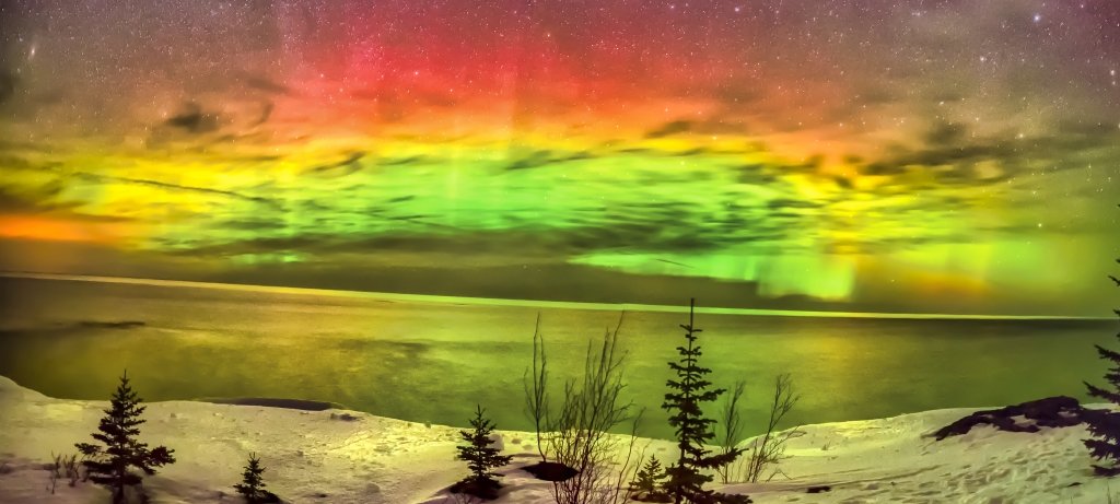 w Peninsula of Michigan with northern lights over Lake Superior