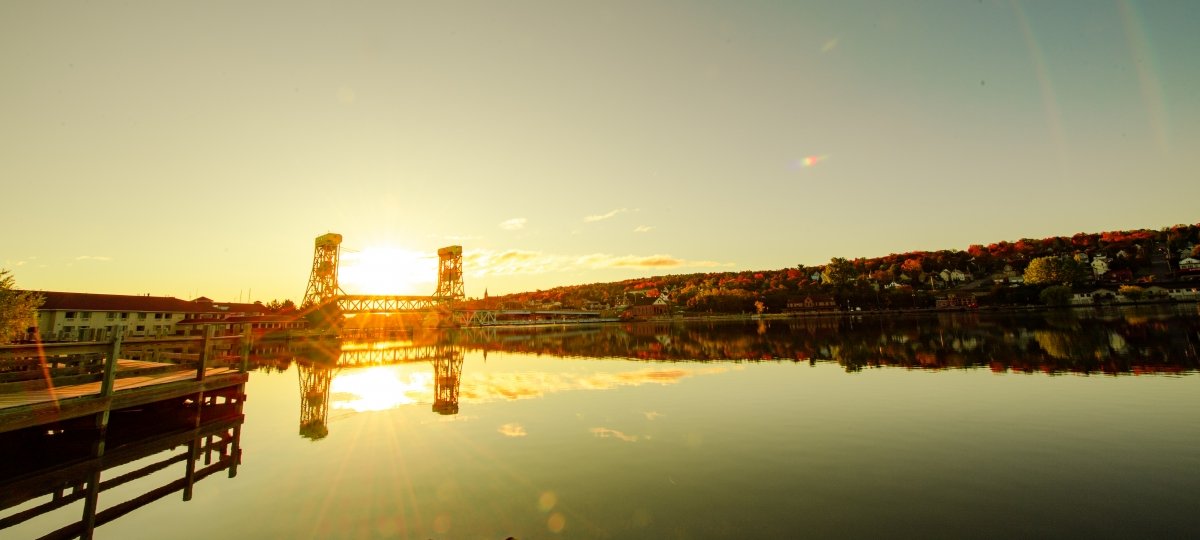 The sun sets behind the Portage Lake Lift Bridge.