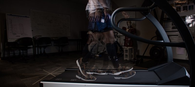 A slow motion image of a person walking on a treadmill.