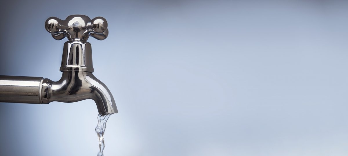 A faucet with water falling from the spout