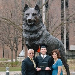 Zach and his parents by the Husky statue in 2018 when he graduated.
