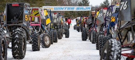 Racers in student-built off-road vehicles line up for the start of the 2023 Baja Blizzard Winter Invitational. (Image credit: Mackenzie Johnson)