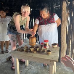 An MTU student makes chocolate with a village resident in a small Yucatan Peninsula community.