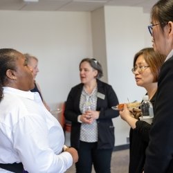 Three researchers talk at a Michigan Tech-hosted event at the University of the District of Columbia as one of the first face-to-face gatherings for the institutions, who are collaborating on various projects.
