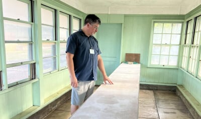 Joel Neves looking at a counter in an empty building.