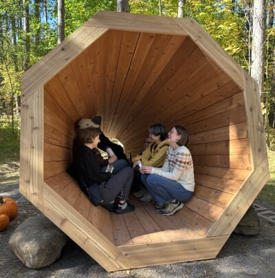 Five students sitting inside the completed megaphone.