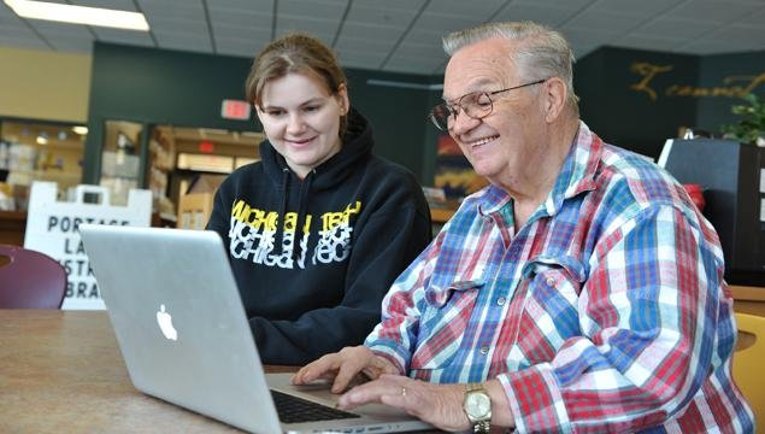 BASIC tutor and patron Michigan Tech students assist BASIC patrons on Saturday mornings at the Portage Lake District Library.