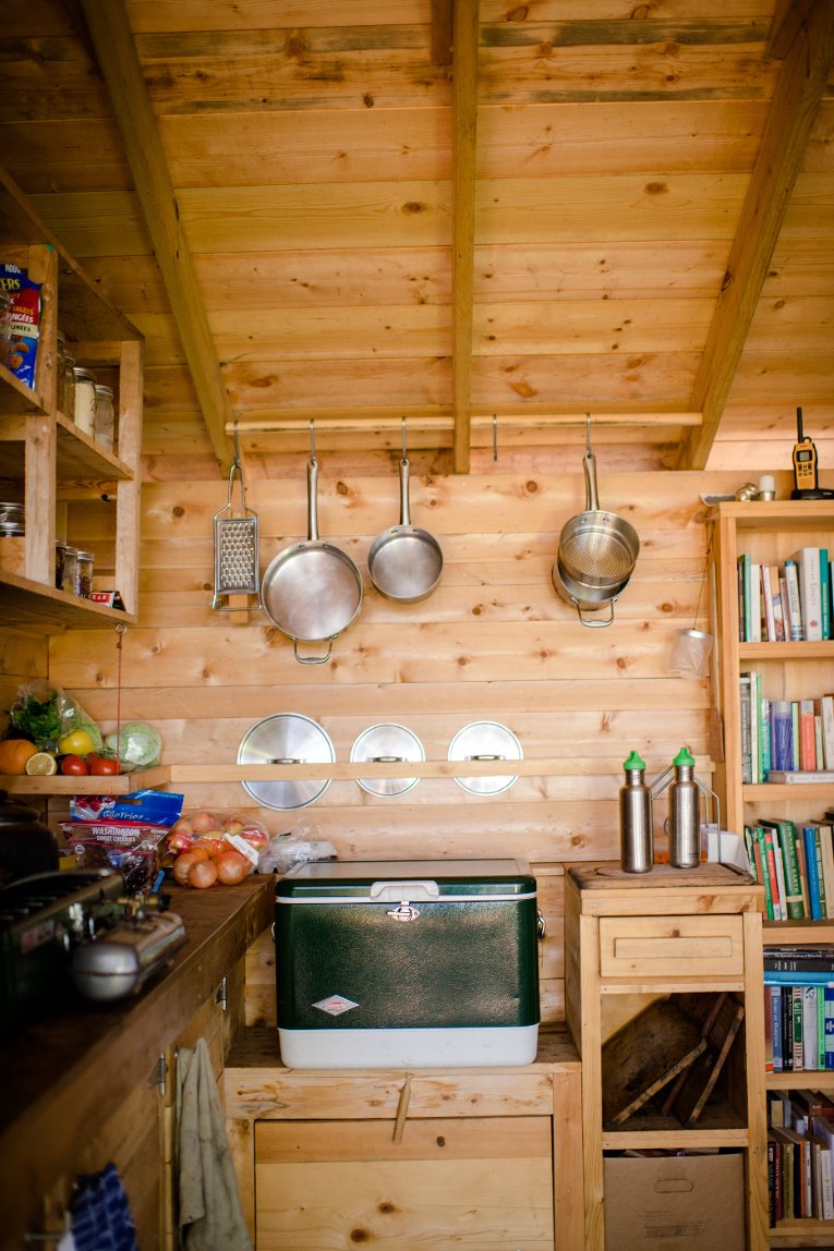 Rabbit Island kitchen Fresh produce, cooler, a lending library of eclectic selections stocked by readers in residence over the years... "even what's on the shelves is fascinating," says geotourist Robin Hammer Mueller.