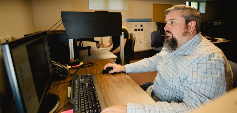 man sitting at computer