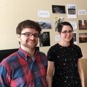 Mads Howard and Kihn Hughes in front of the Art and Nature mindful cell phone photos exhibit at Omega House, where people seek hospice services.