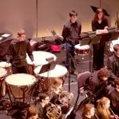 Student playing large drums in the Keweenaw Symphony Orchestra.
