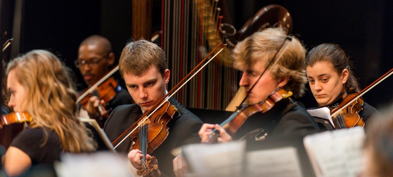 Students performing in the Keweenaw Symphony Orchestra, a closer view of the violinists.