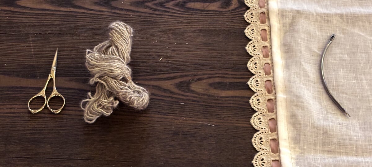 An oak table top, with scissors, human hair, and soft fabric