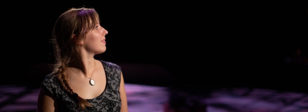 Actress looks towards the crowd during a performance.