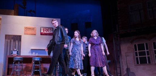 Students performing West Side Story on the stage of the Rozsa Center for the Performing Arts.