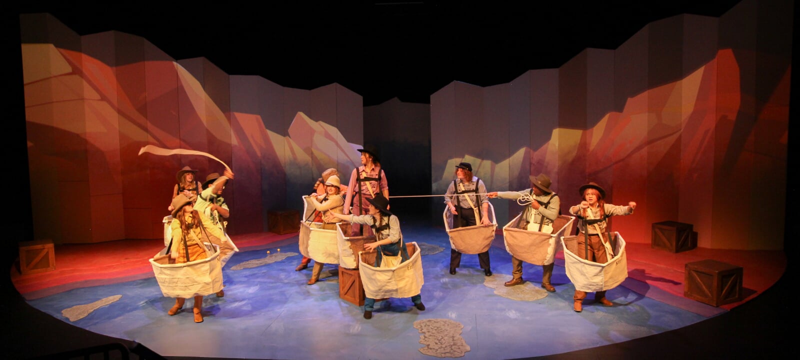 Actors in cloth boats in the production of Men on Boats