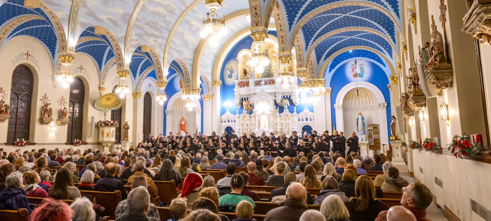 Singers in a choir performing before a live audience