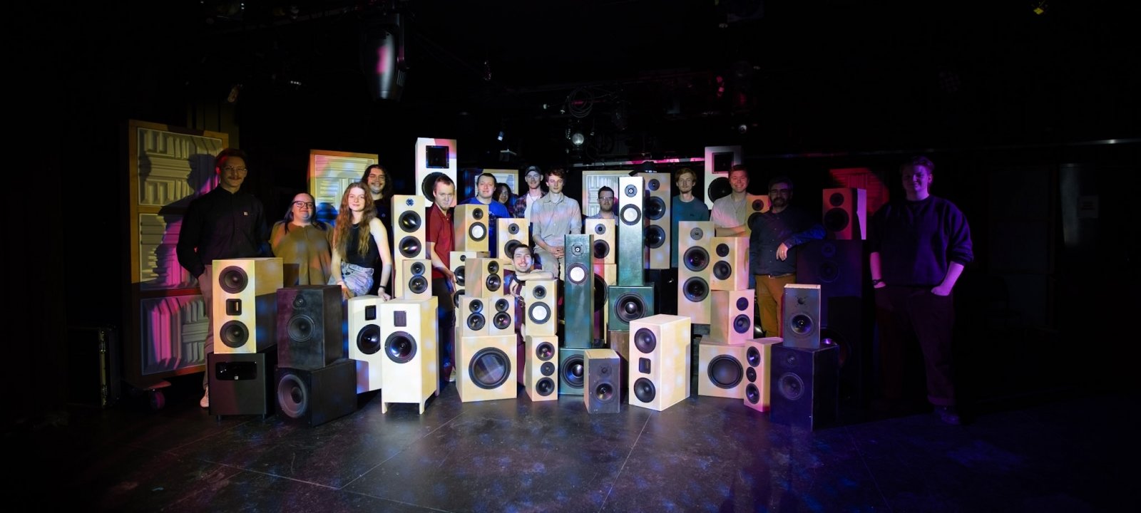 Students pose in a photo with the loudspeakers that they designed and built.