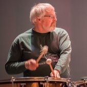 Member of the Keweenaw Symphony Orchestra plays the drums.