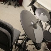 Close up of chairs and music stands against a corner inside the Hagan Practice Room.