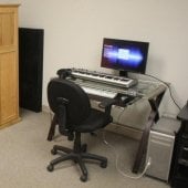 Wooden equipment cabinet and a computer inside the Hagan Practice Room.