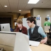 Two students collaborating at a computer in the HDMZ.