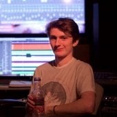 Student sitting inside the Film Mixing Studio.