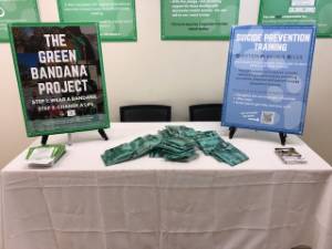 image of table with green bandana promotional material on it