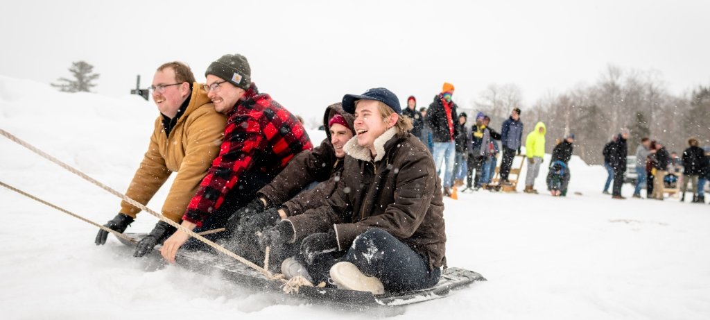 Students playing tug-o-war in the snow.