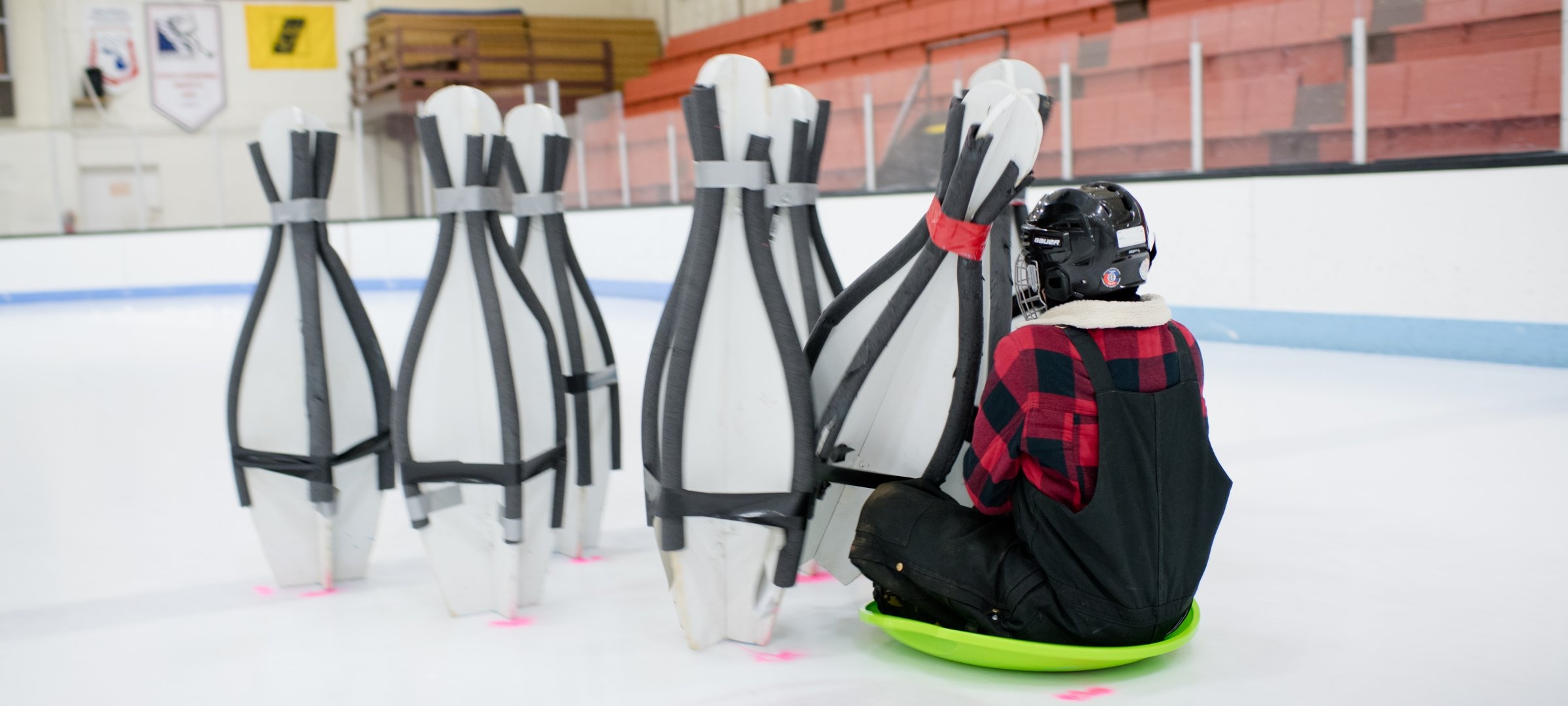 Student hitting pins during ice bowling.