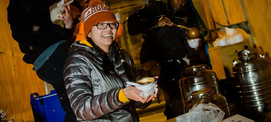 Person holding a bowl of chili.