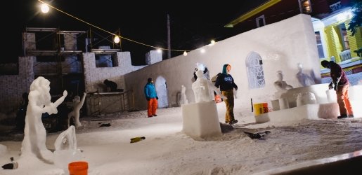 Students working on a statue at night.